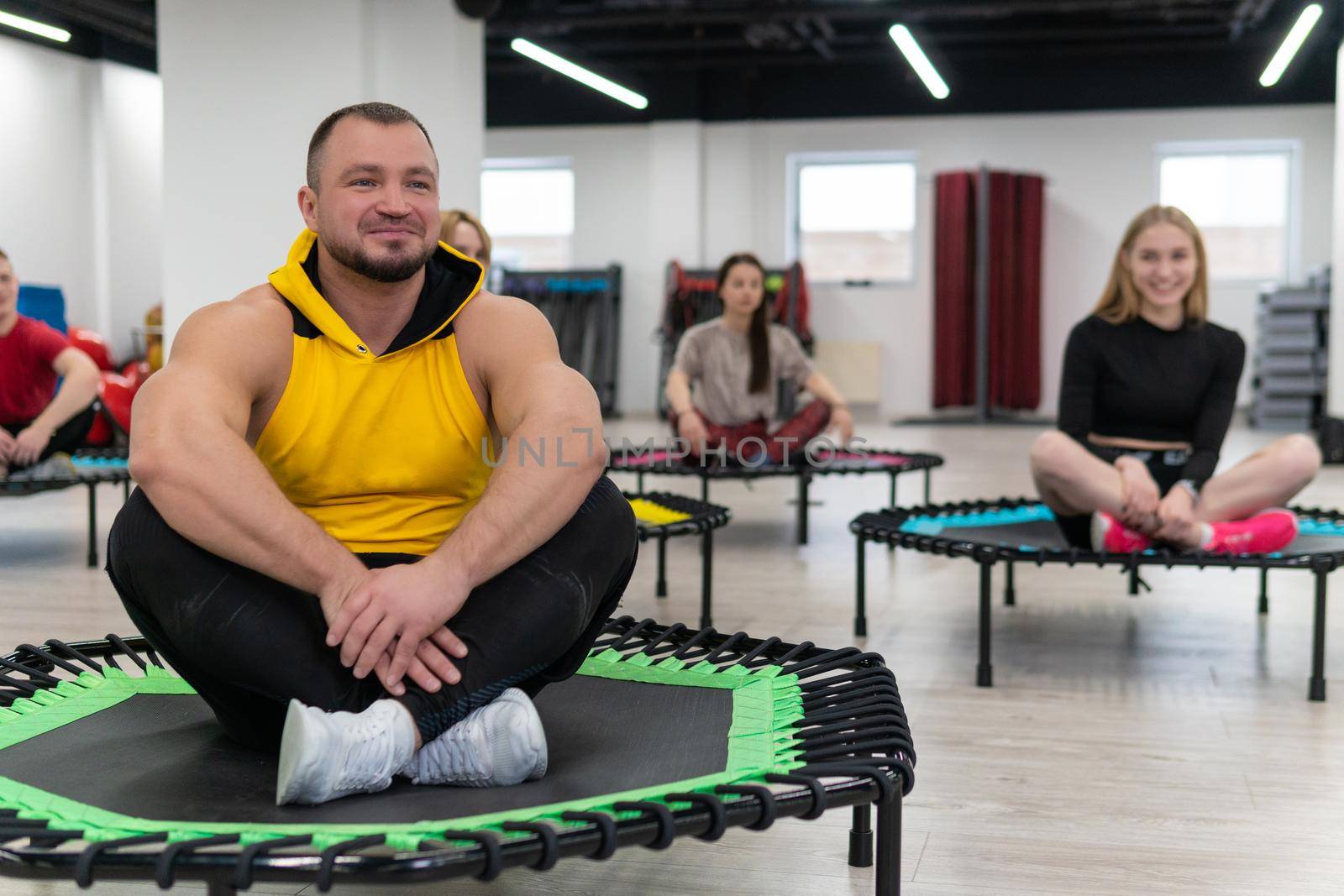 Women's and men's group on a sports trampoline, fitness training, healthy life - a concept trampoline group batut workout men, from lifestyle athletic for sporty from sport shaping, smiling sportswear. Legs beauty loss, exercising by 89167702191