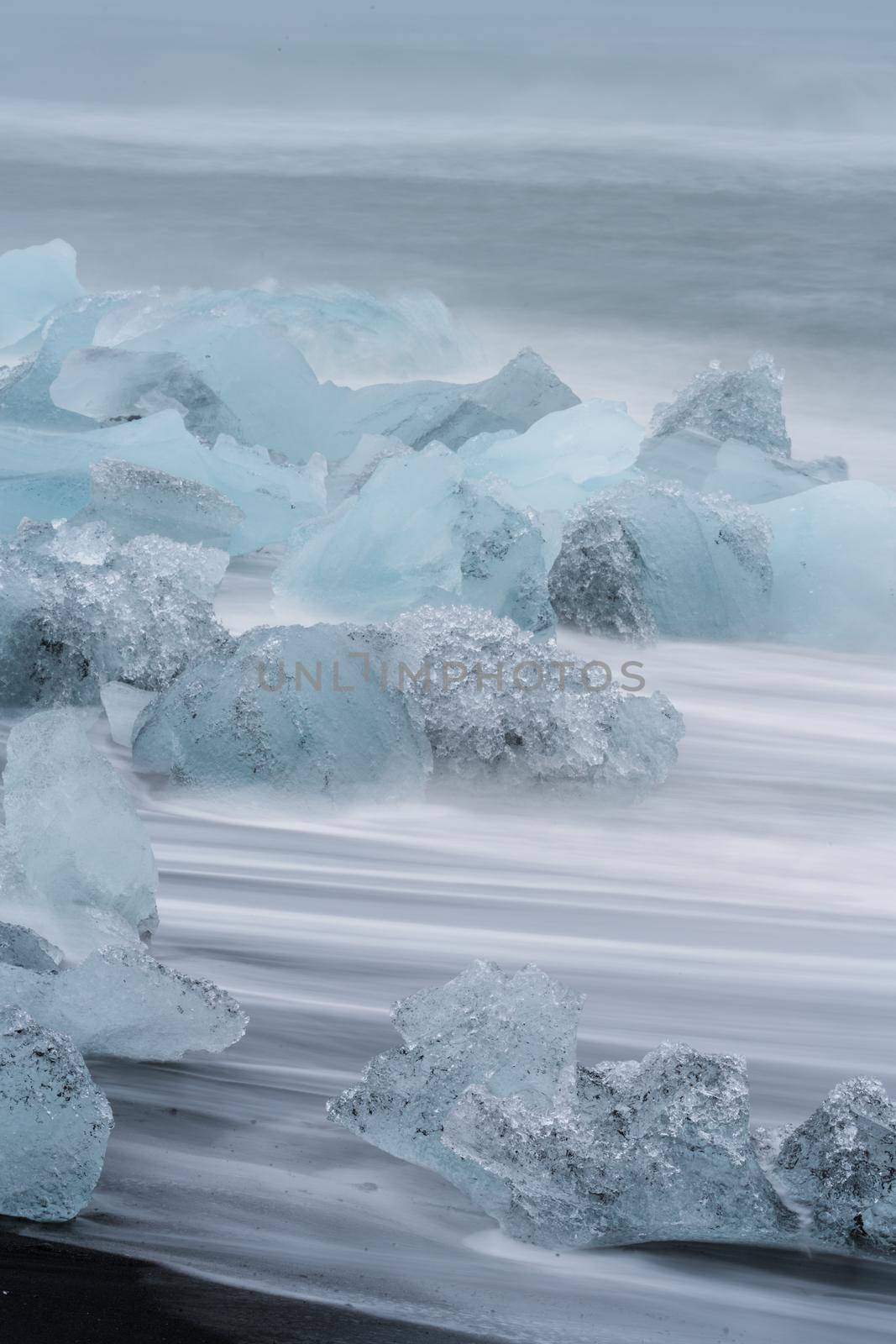 Long exposure of icebergs over Jokulsarlon beach, vertical composition by FerradalFCG