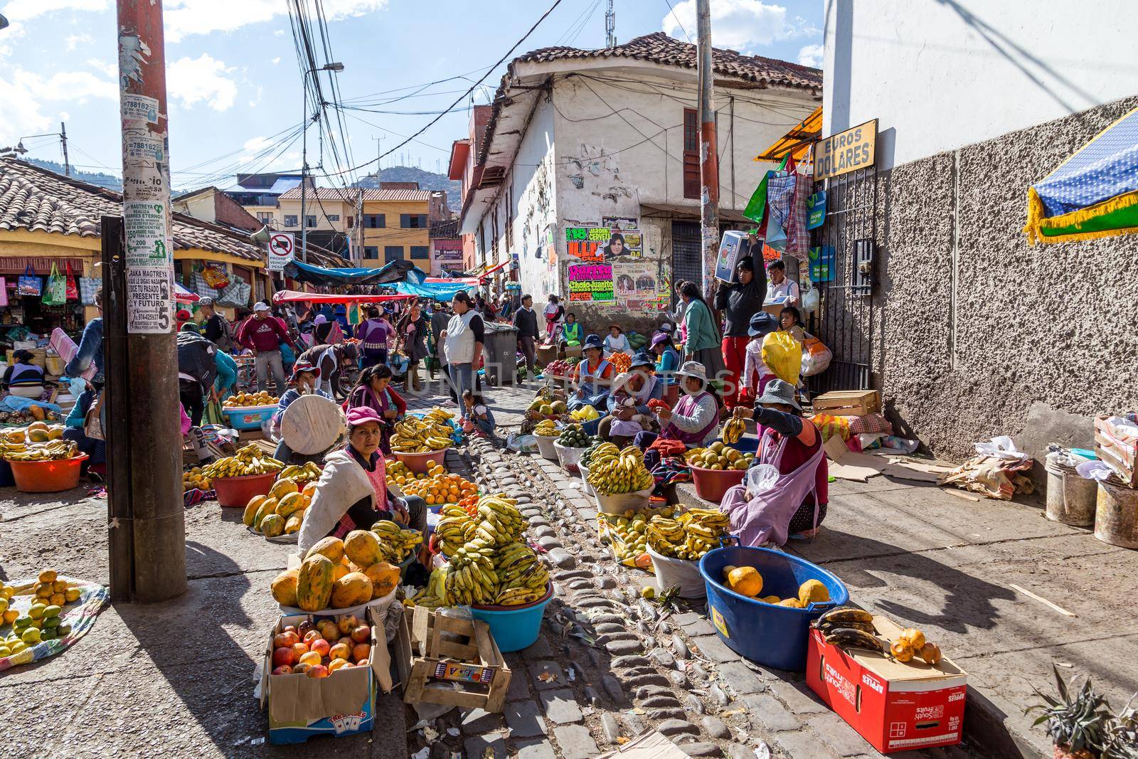 Cusco, Peru - August 08, 2015: People selling and buying fruits at a market in the steets