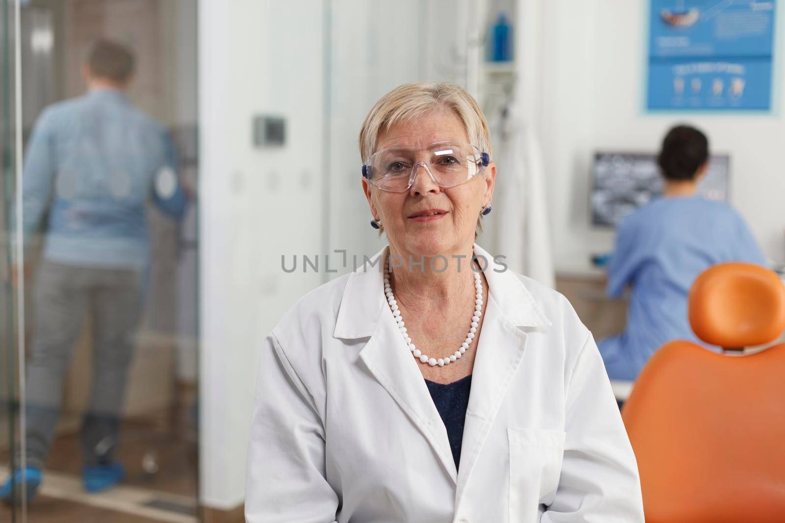 Portrait of senior woman dentist working in stomatological hospital office room by DCStudio