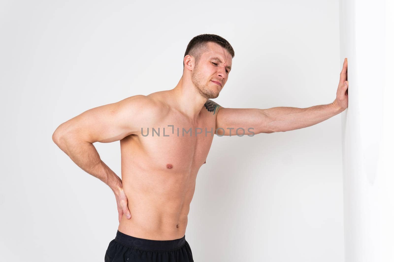 A man back pain keeps his hand on his back hurt painful, cramp spine male background adult, human neck therapy, lower suffer attractive by 89167702191
