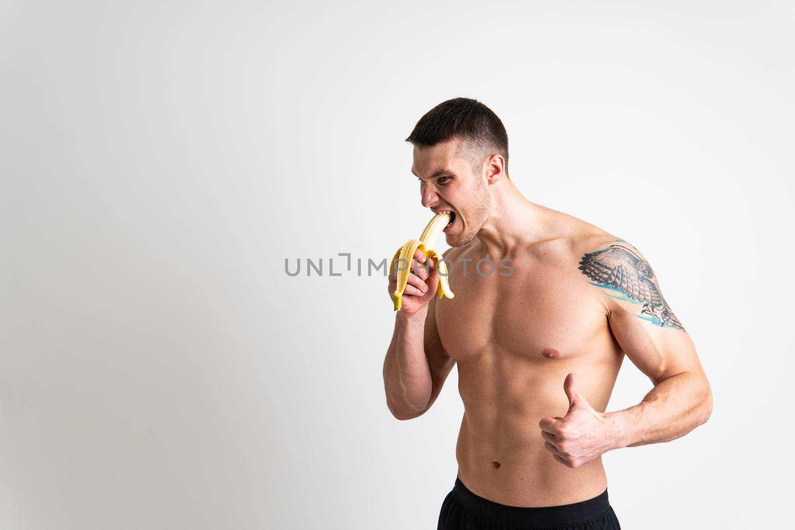 Man holds apples in fitness white background isolated healthy fit health, diet male strong athlete, person. Guy nutrition, bodybuilder chest
