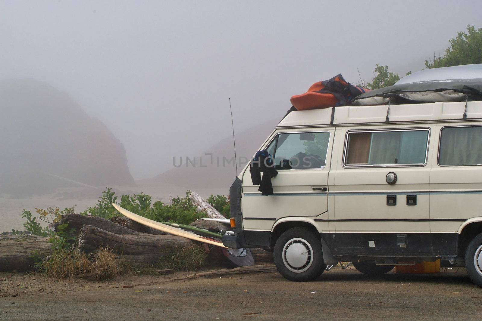 A parked van loaded with surfboards and gear parked at the beach in Tofino in British Columbia. High quality photo