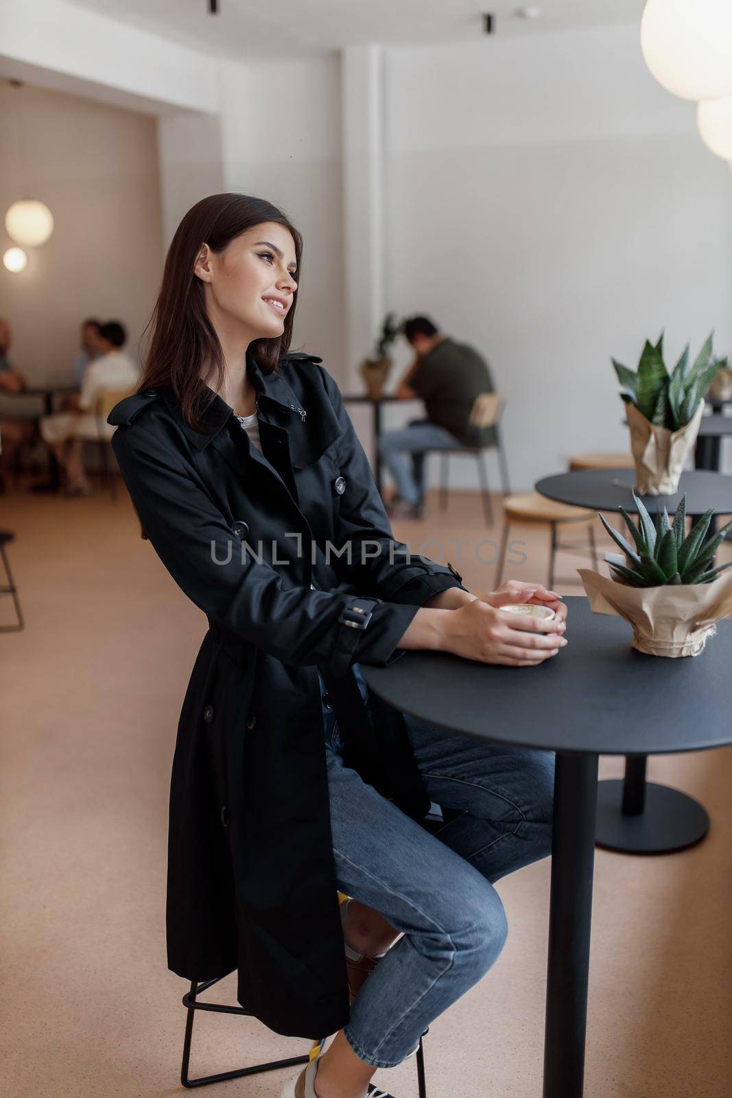 beautiful women in a coffee shop with a cup of coffee.