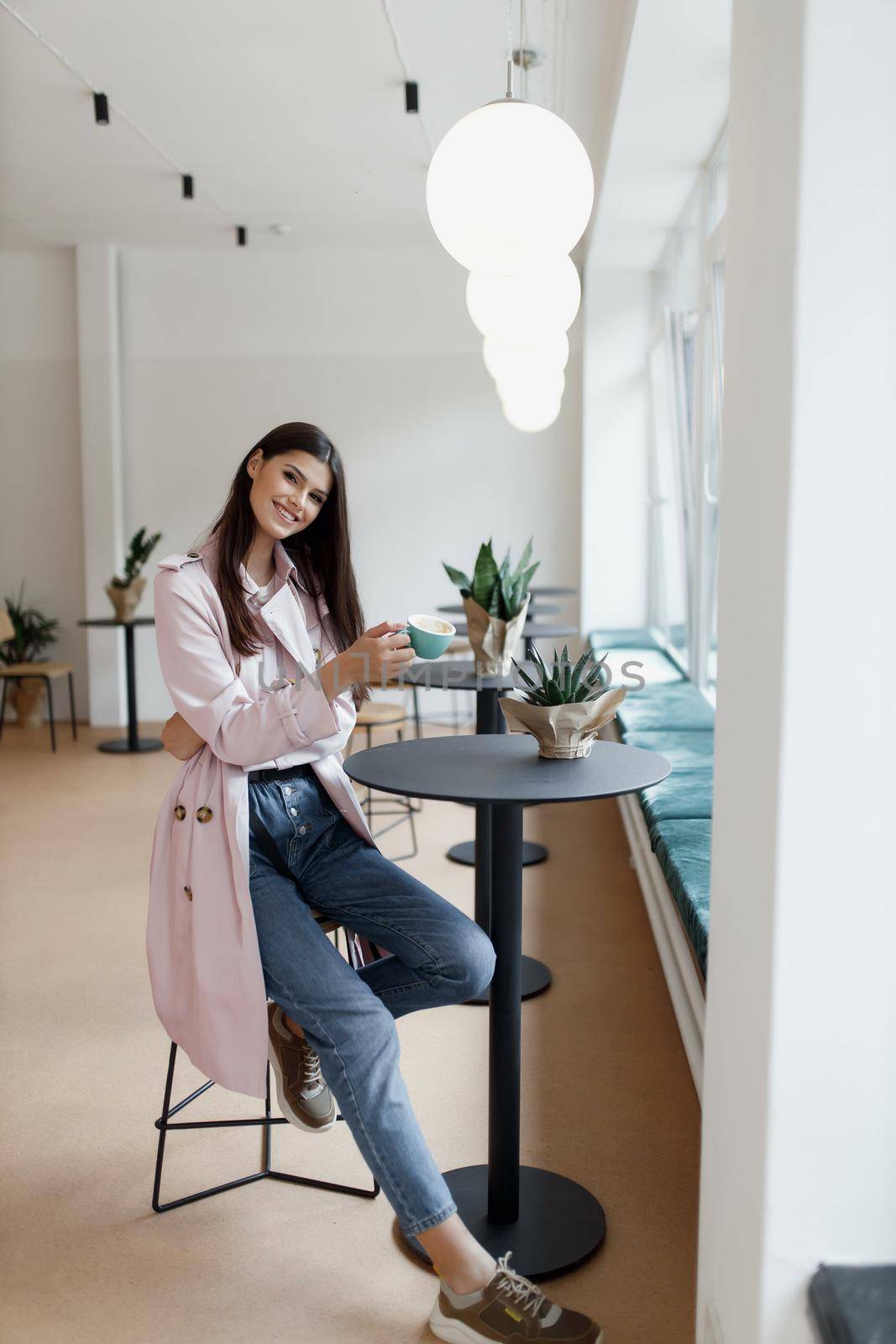 beautiful women in a coffee shop with a cup of coffee.