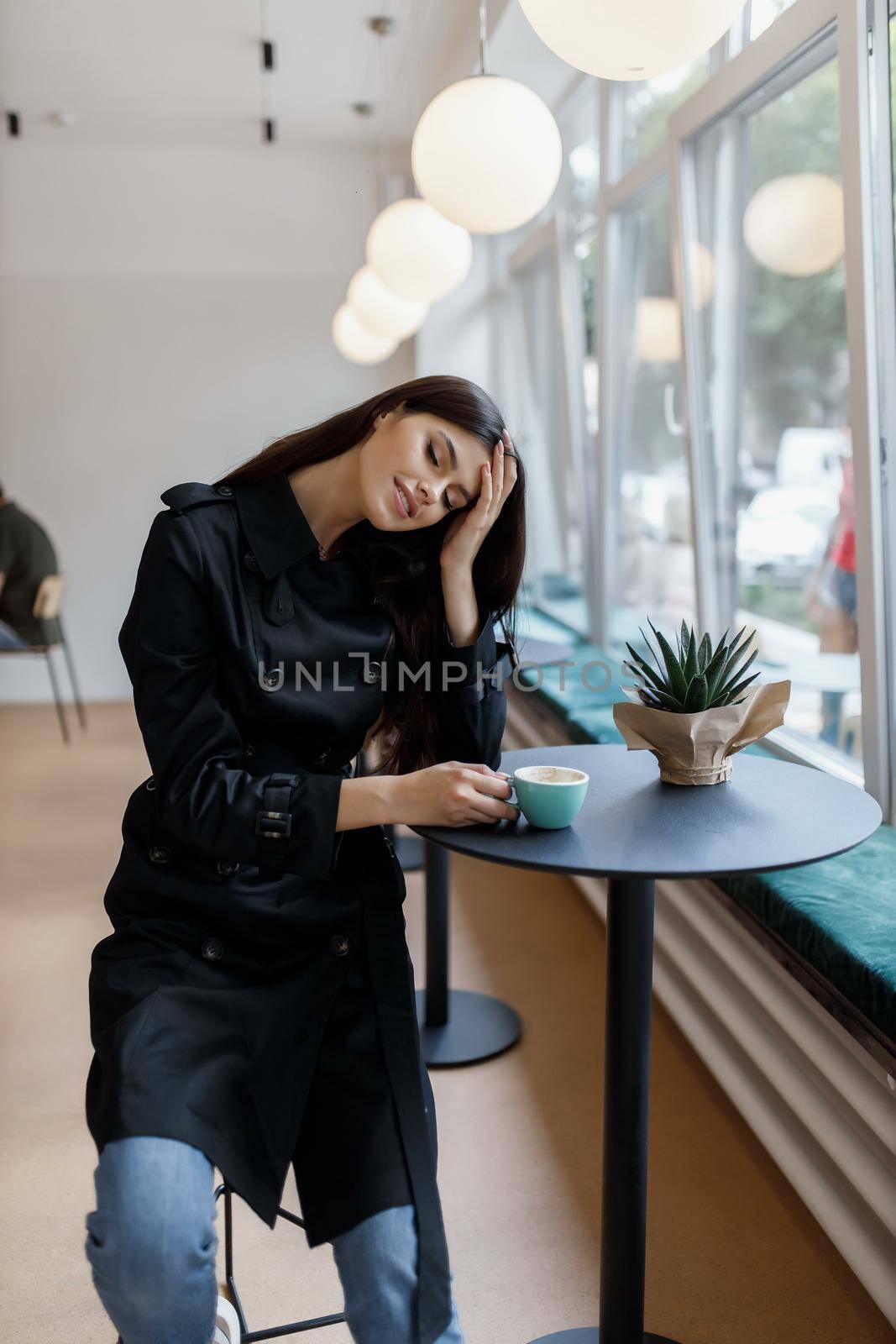beautiful women in a coffee shop with a cup of coffee.