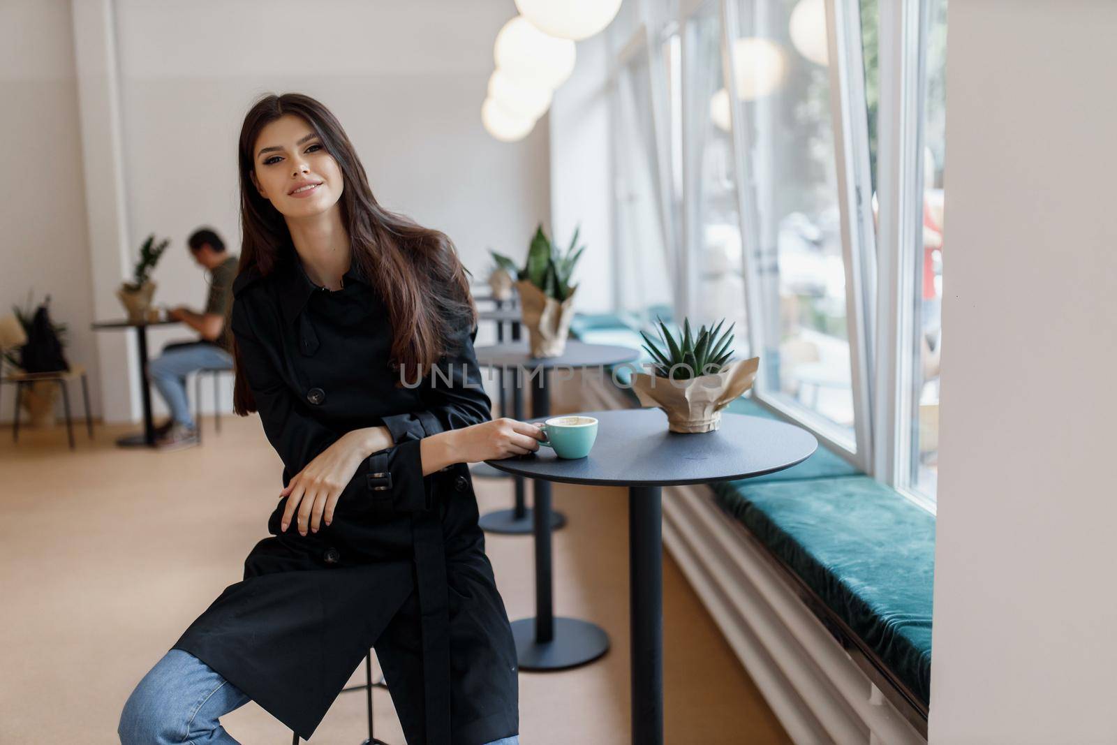 beautiful women in a coffee shop with a cup of coffee.