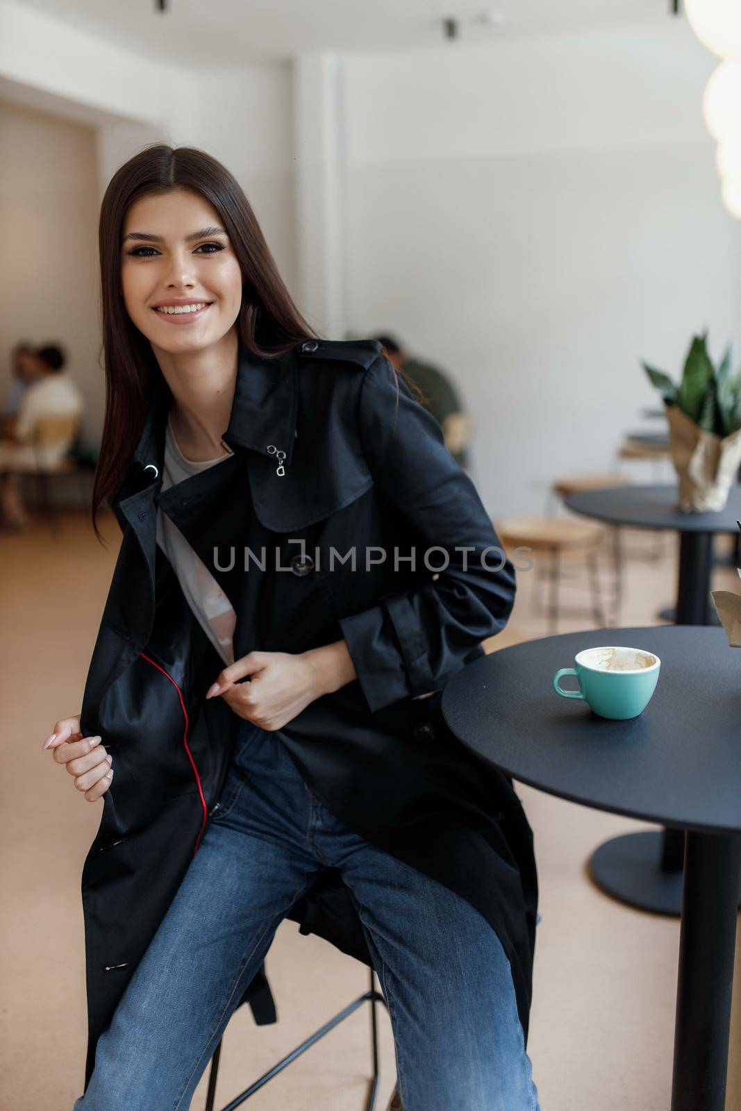 beautiful women in a coffee shop with a cup of coffee.