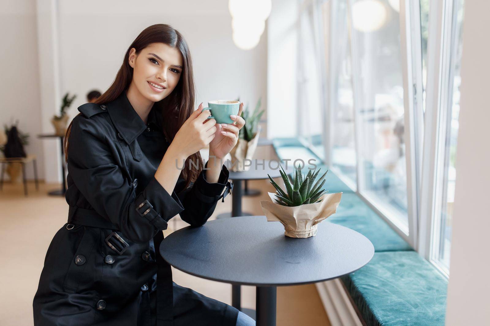 beautiful women in a coffee shop with a cup of coffee.