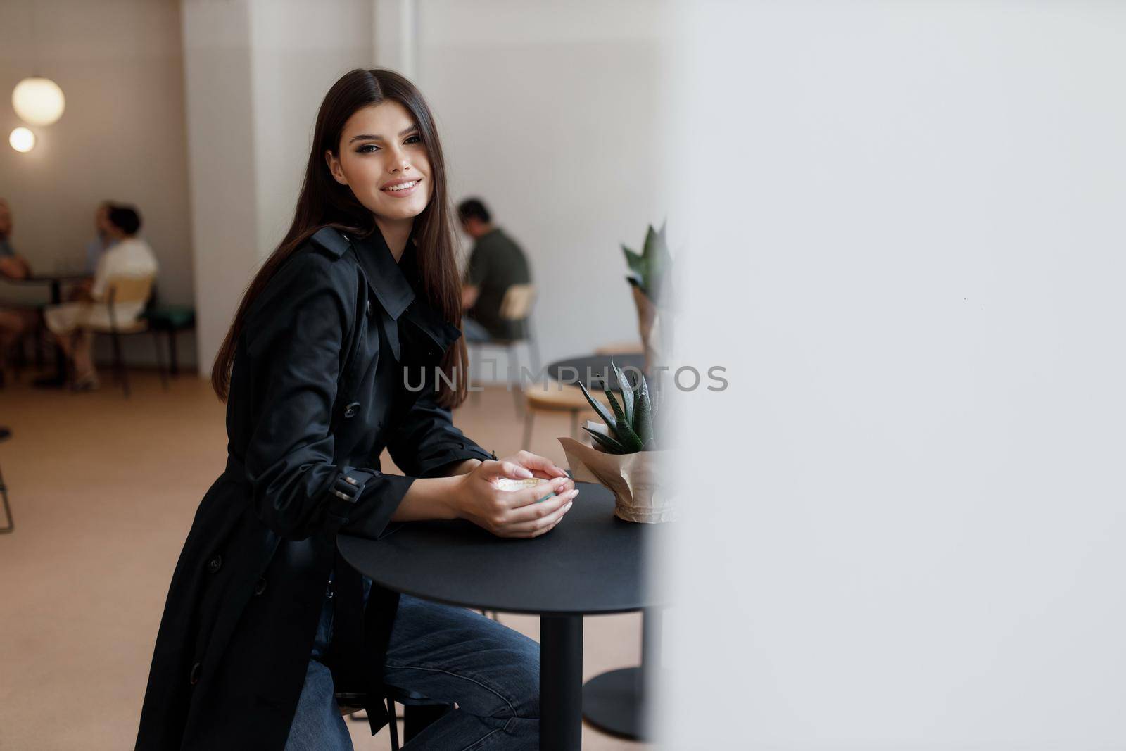 beautiful women in a coffee shop with a cup of coffee.