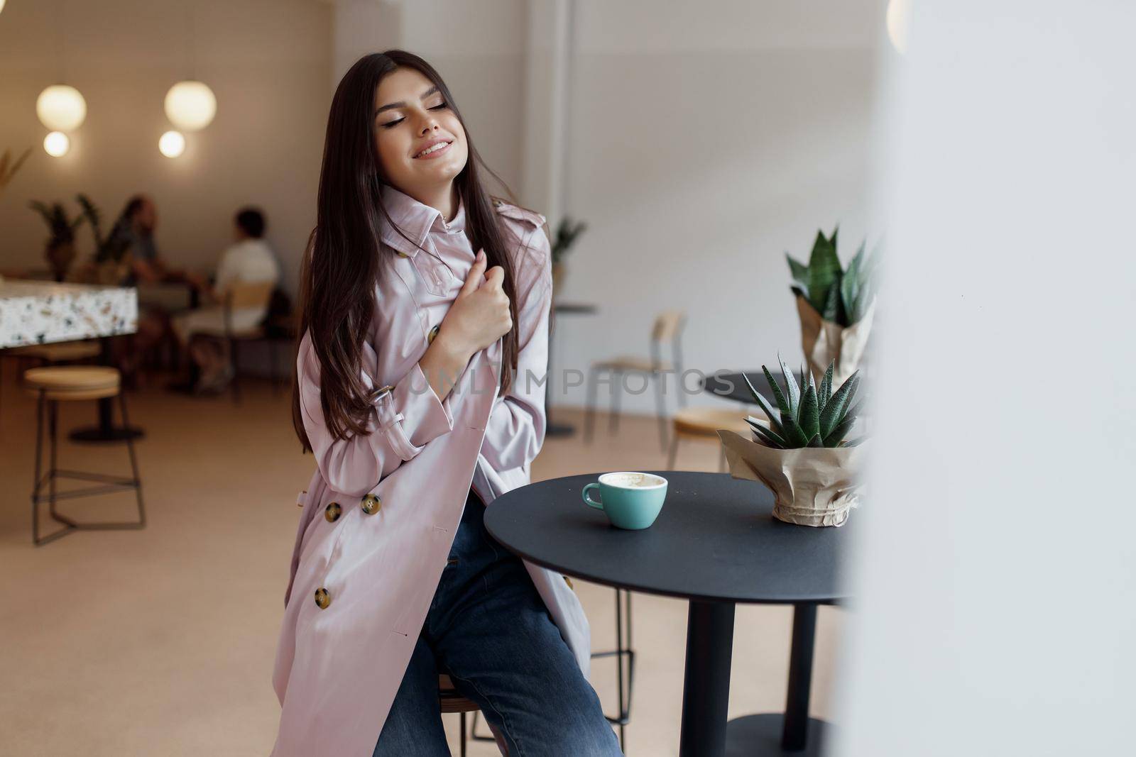 beautiful women in a coffee shop with a cup of coffee.