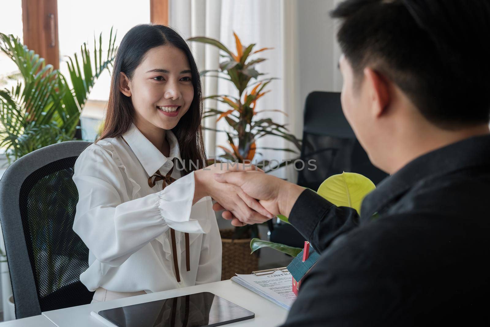 Business people handshake for teamwork of business merger and acquisition, successful negotiate, hand shake, two asian business people shake hand with partner to celebration partnership and business deal concept