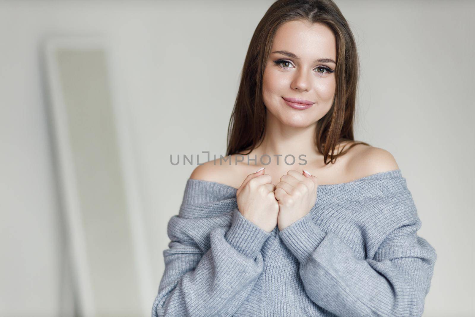 Young beautiful cozy woman indoor by splash