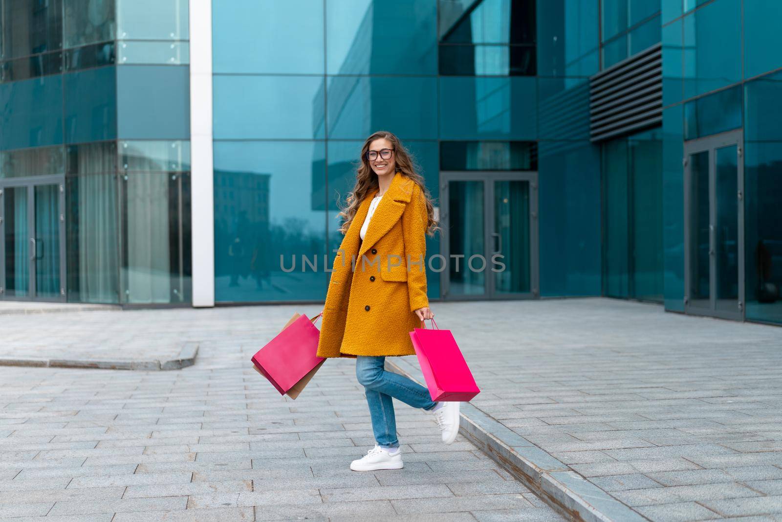 Business Woman With Shopping Bags Dressed Yellow Coat Walking Outdoors Corporative Building Background Caucasian Female Business Person Office Building Stylish Businesswoman Season Sale full length