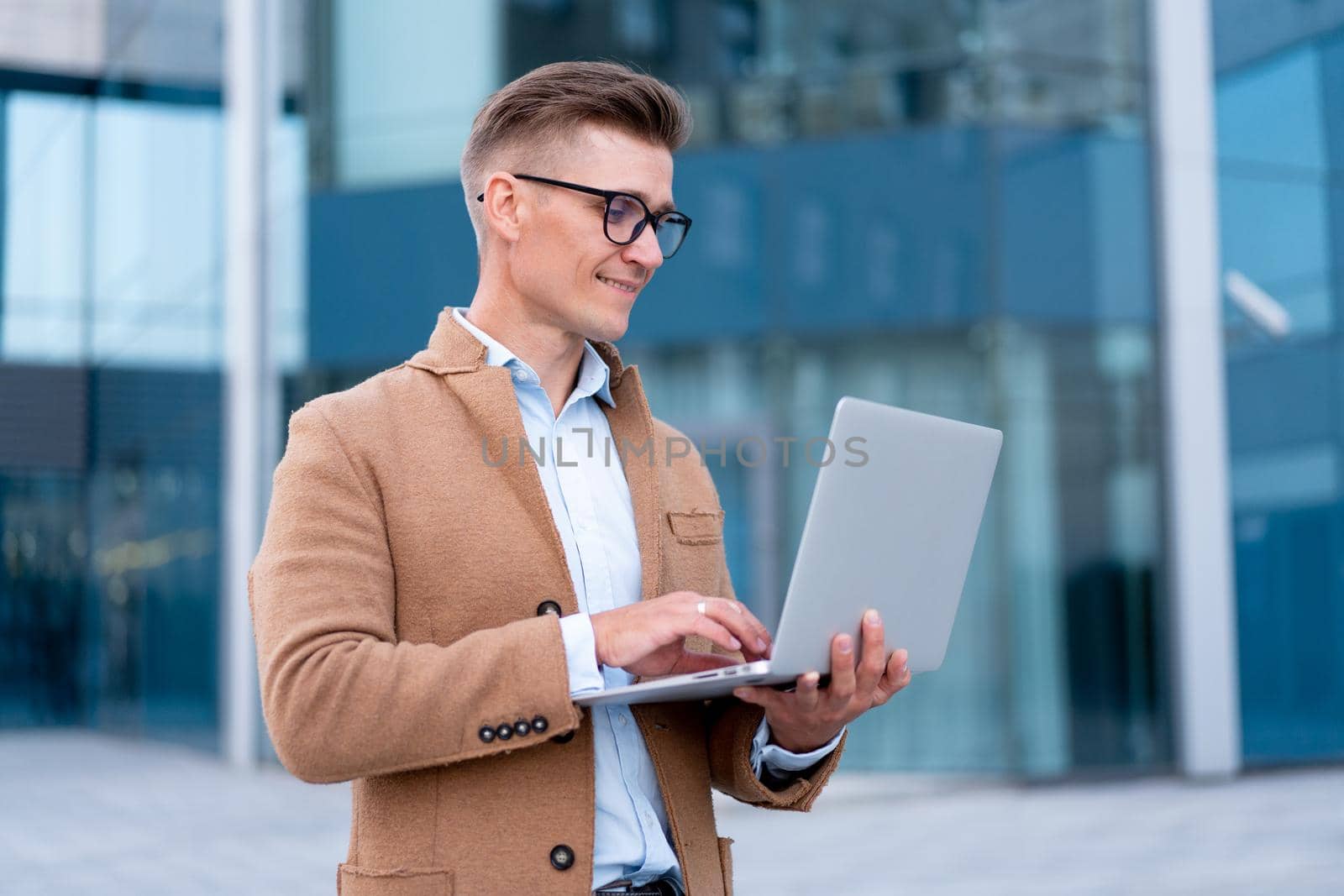 Business. Businessman Using Laptop Outdoor Adult Caucasian Male Business Person Eyeglasses Dressed Hipster Jacket Outside Smiling Happy Positive Emotions Sunlight Background Big City Street