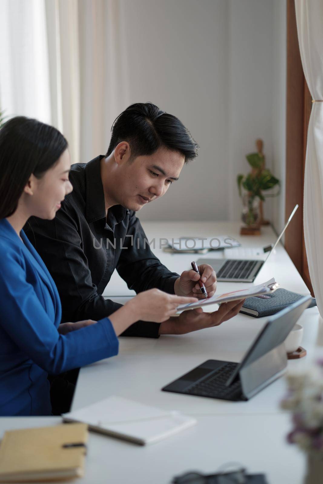 Business People Talking Discussing with coworker planning analyzing financial document data charts and graphs in Meeting and successful teamwork Concept.