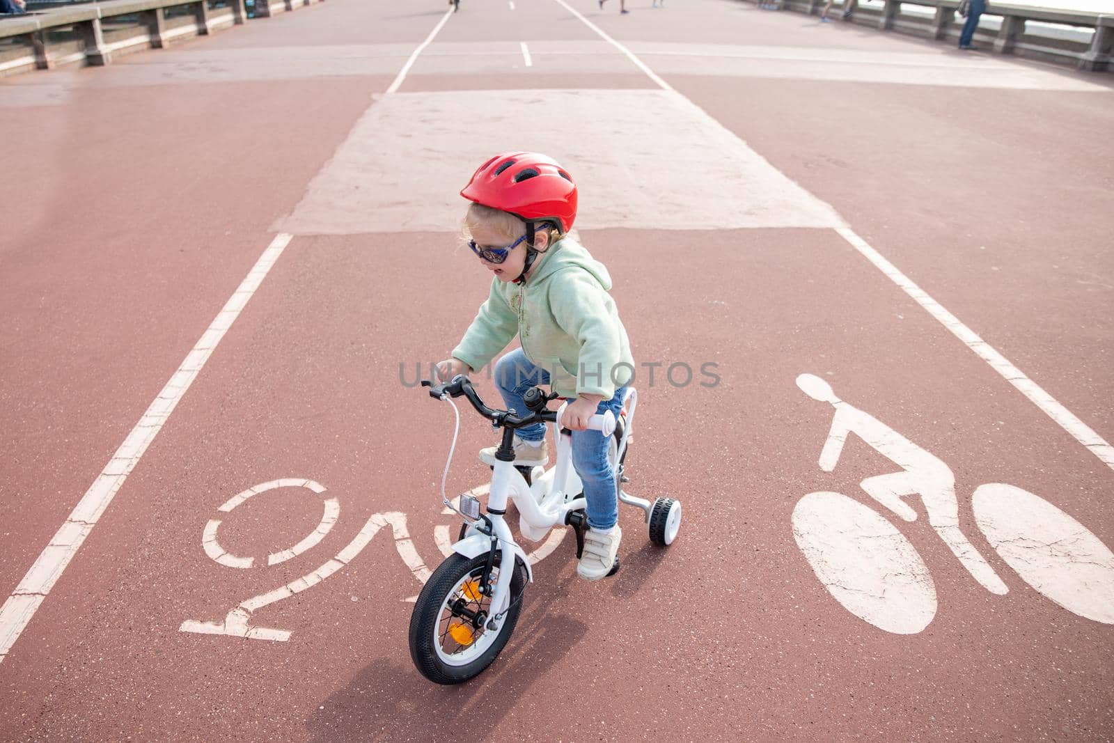 Girl learns riding a four-wheeled bicycle