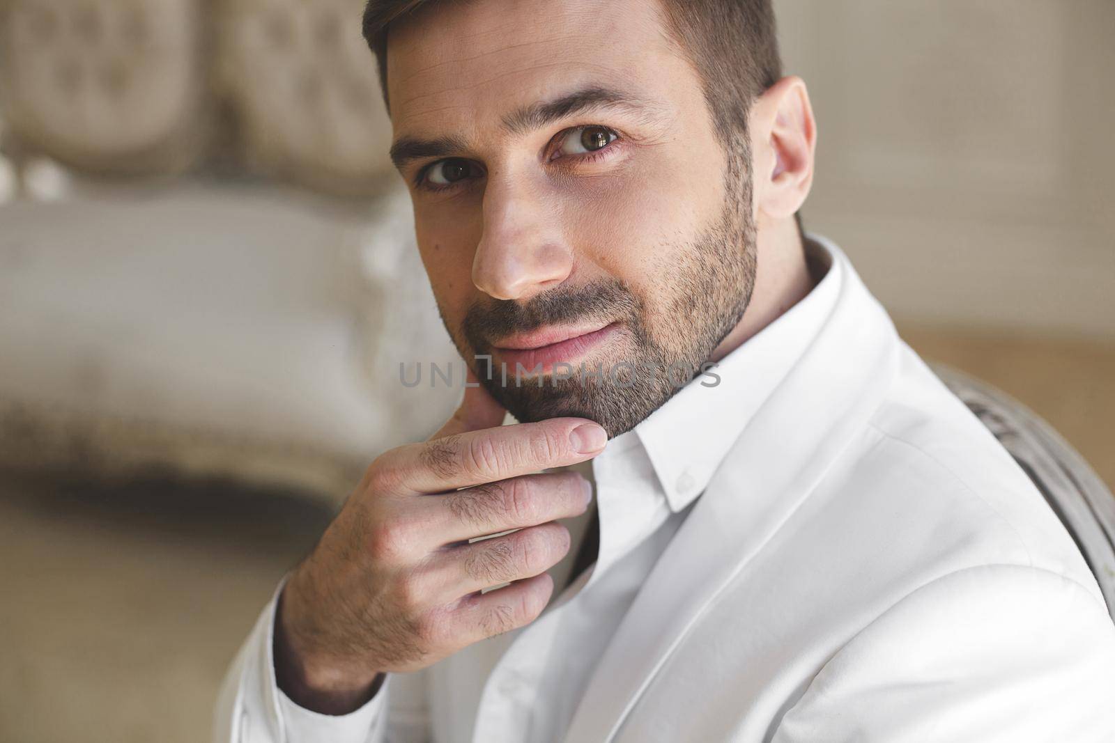 Elegant young handsome man with a beard in a white classic suit. by StudioPeace