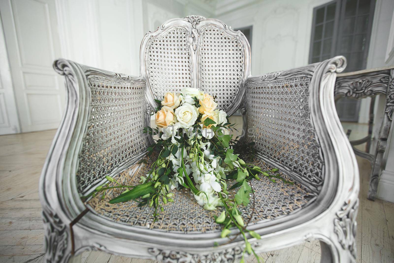 Wedding bouquet lying on a chair in a white Studio. by StudioPeace