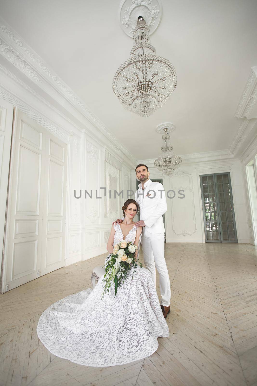 Chic wedding couple groom and bride posing in a white Studio. by StudioPeace
