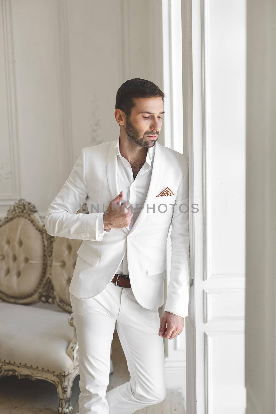 Elegant man with a beard in a white classic suit. by StudioPeace