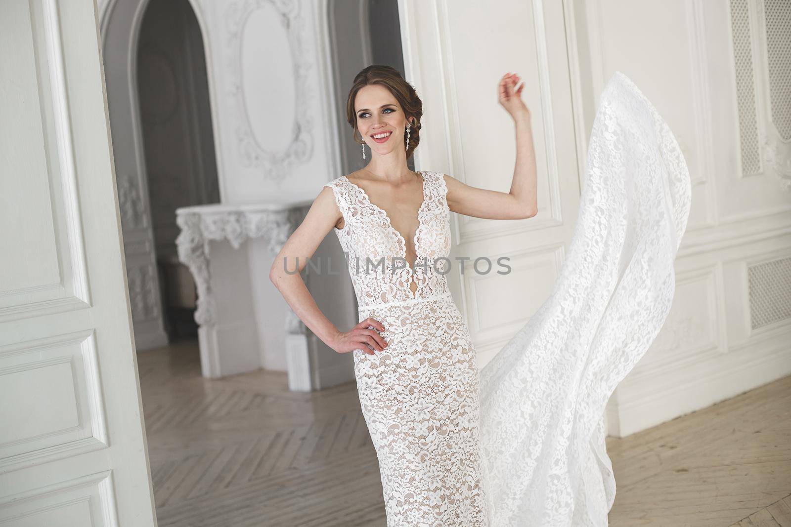 Beautiful bride posing in wedding dress in a white photo Studio.