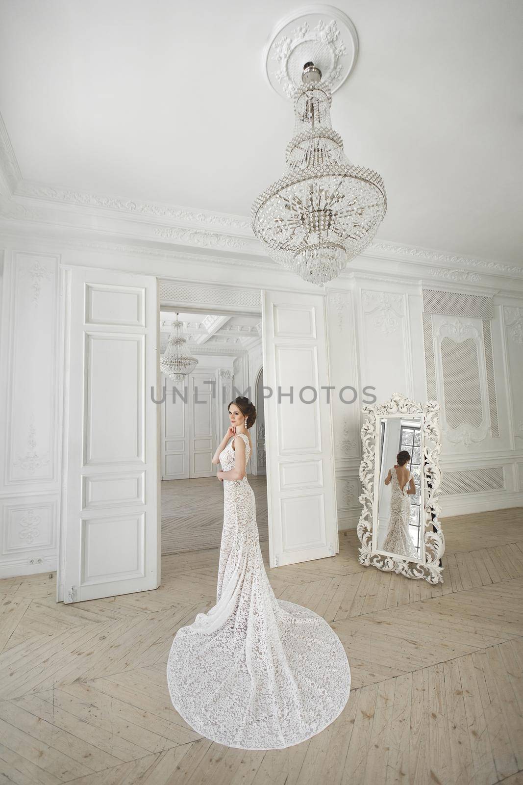 Beautiful bride posing in wedding dress in a white photo Studio.