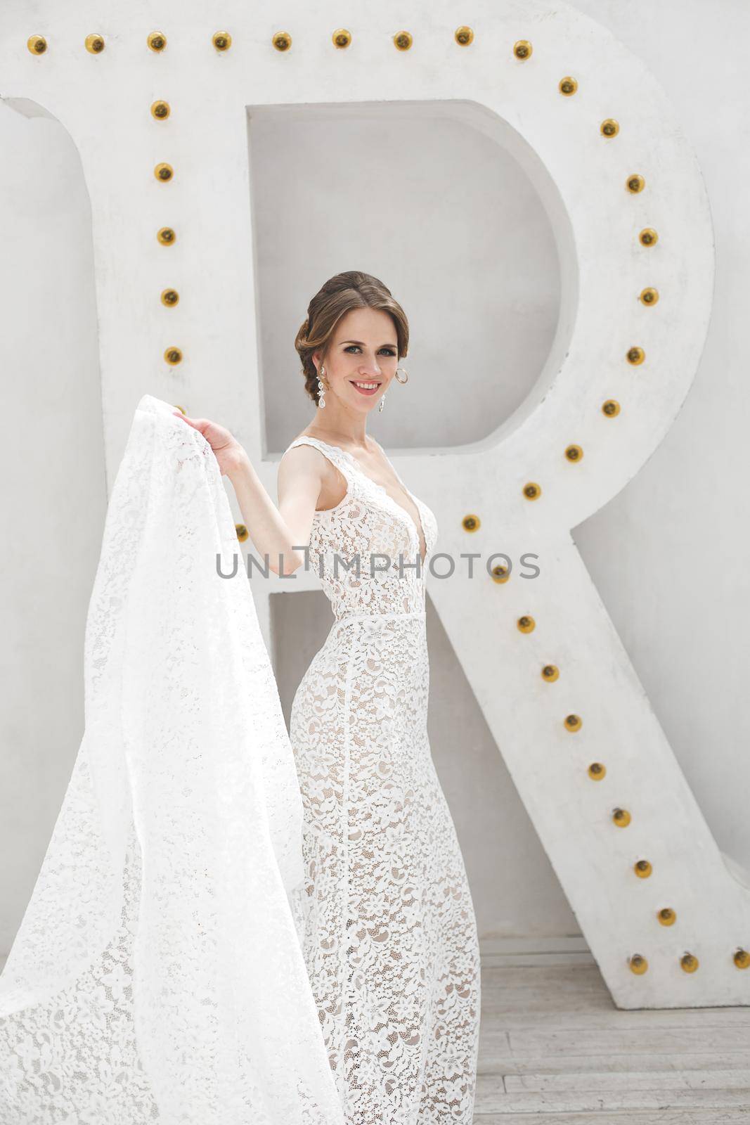 Beautiful bride posing in wedding dress in a white photo Studio.