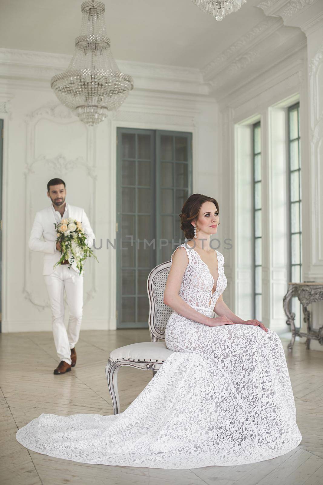 Chic wedding couple groom and bride posing in a white Studio. by StudioPeace