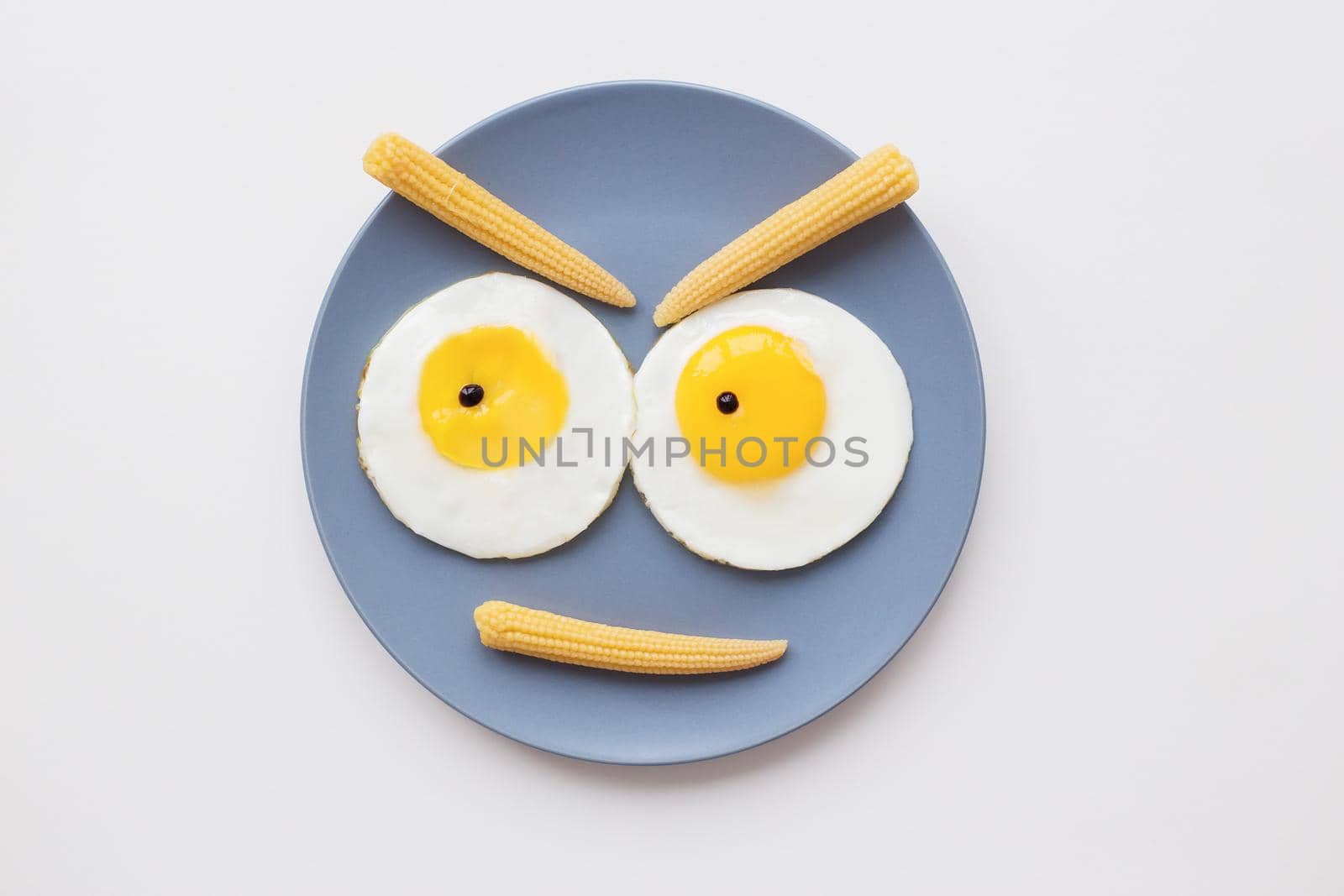 cheerful breakfast, two funny eggs on a plate