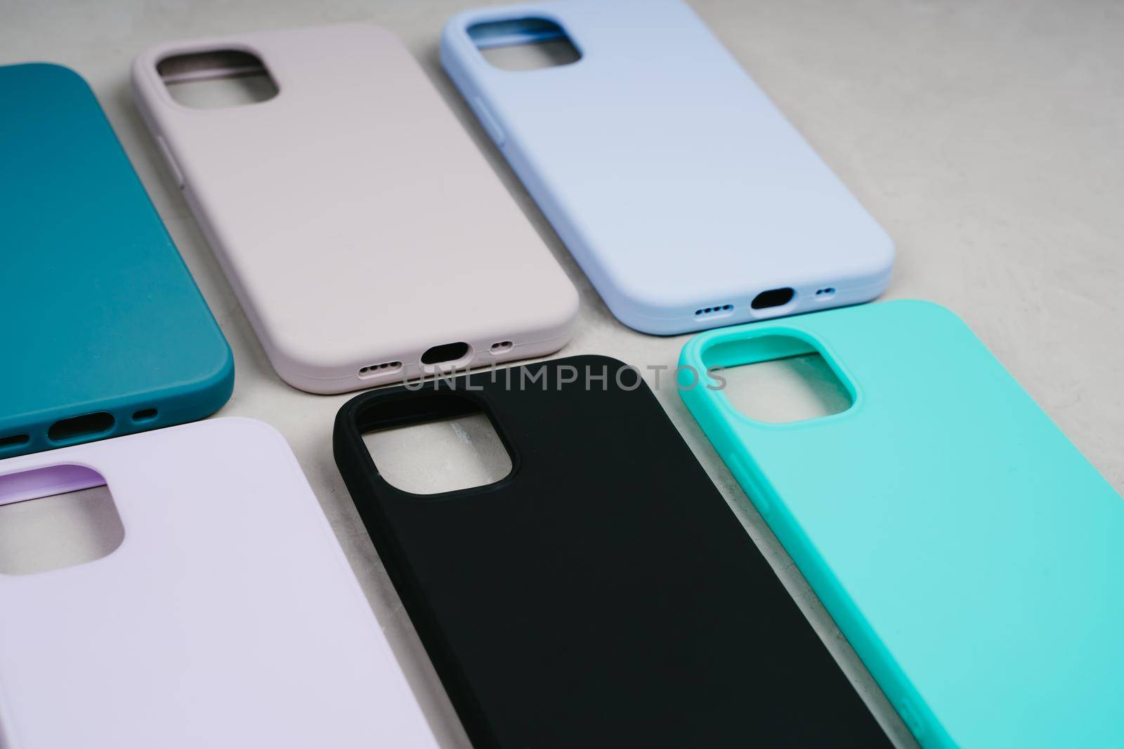 Set of colored silicone cases for smartphone. Cases set for smartphone on grey background. Protection for mobile phone. Colorful silicone phone cases.