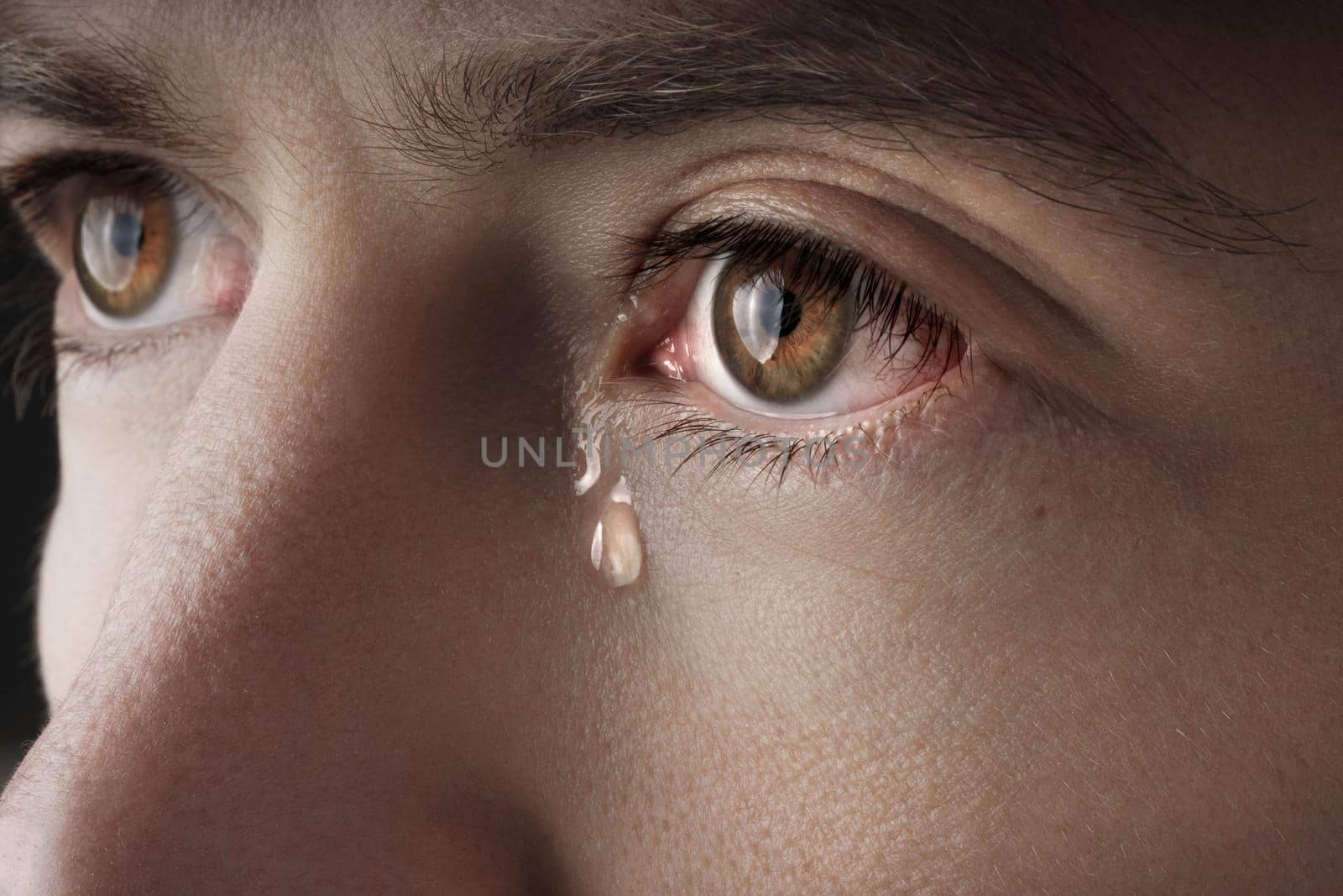 Closeup of young crying man eyes with a tears by DariaKulkova