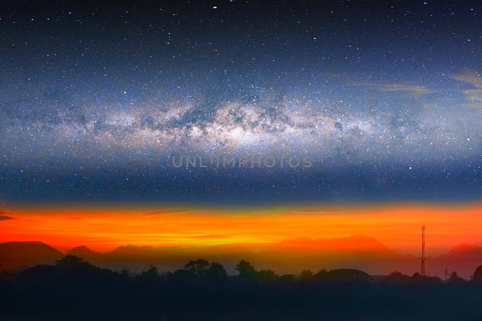 Milky way night landscape sunset light over silhouette mountain, space and stars on sky background