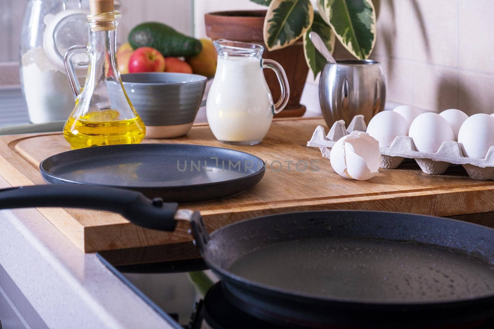 Workplace in the kitchen with ingredients and utensils for baking pancakes. Home cooking food, DIY. Selective focus.