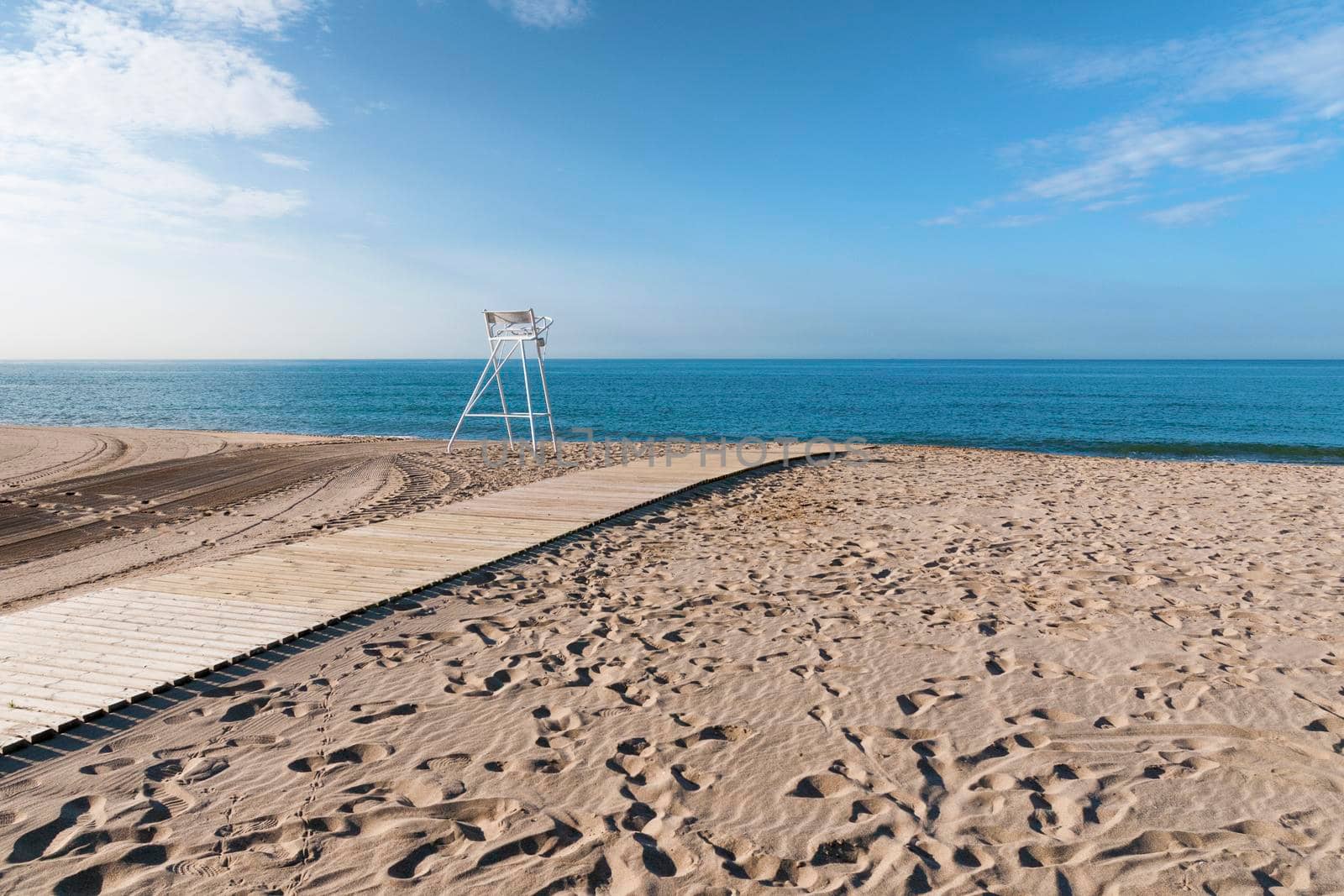 empty sand beach by bright summer day