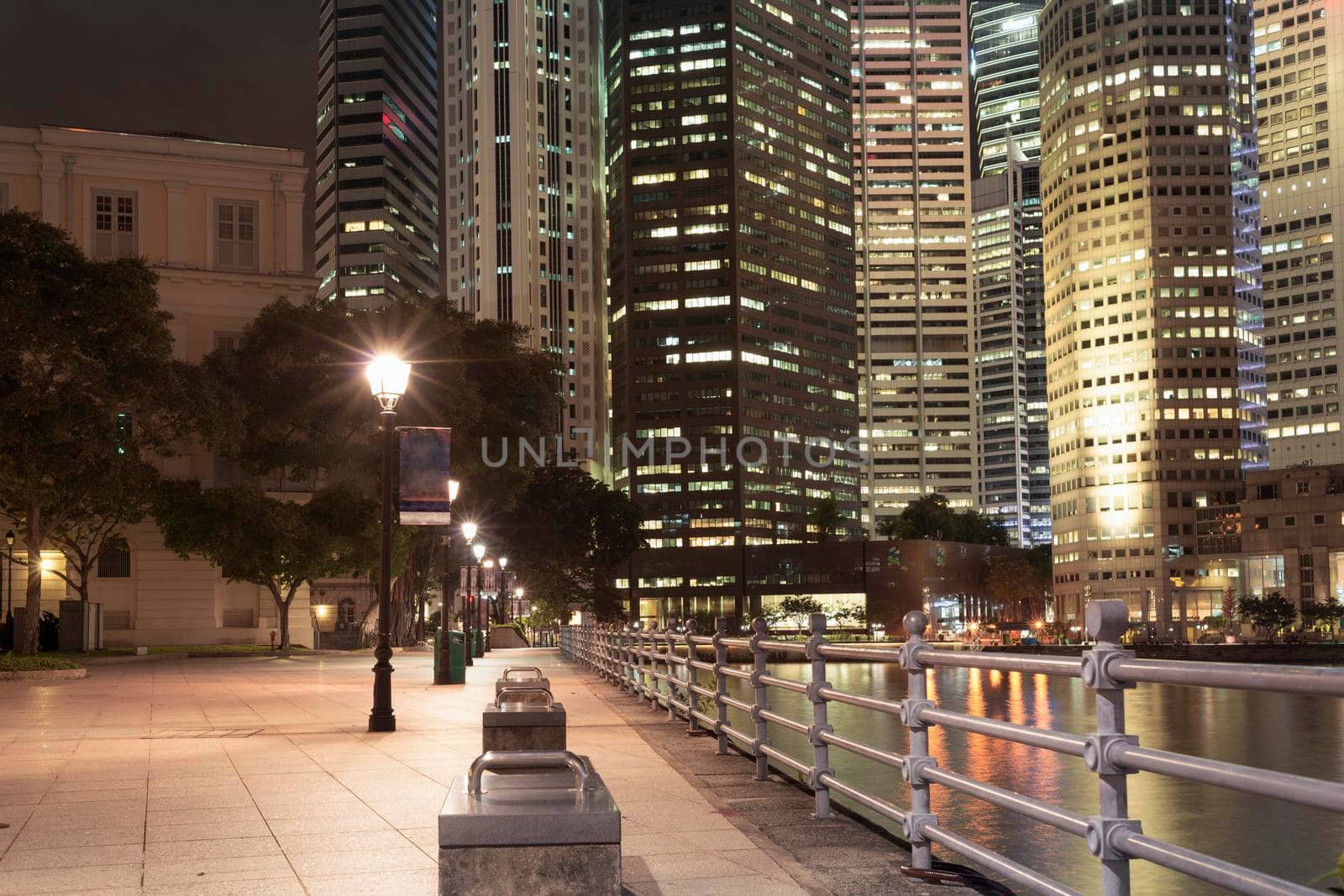 night illumination on river embankment in Singapore downtown