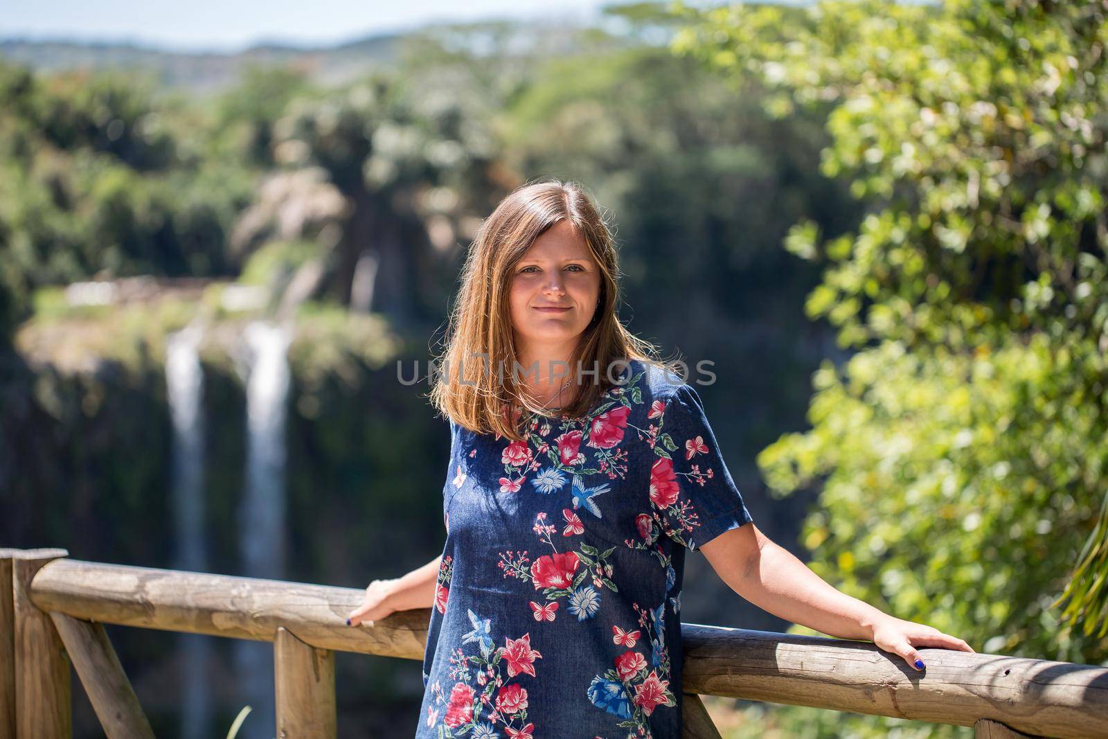 Woman on the background of the waterfall of Chamarel Mauritius. by StudioPeace