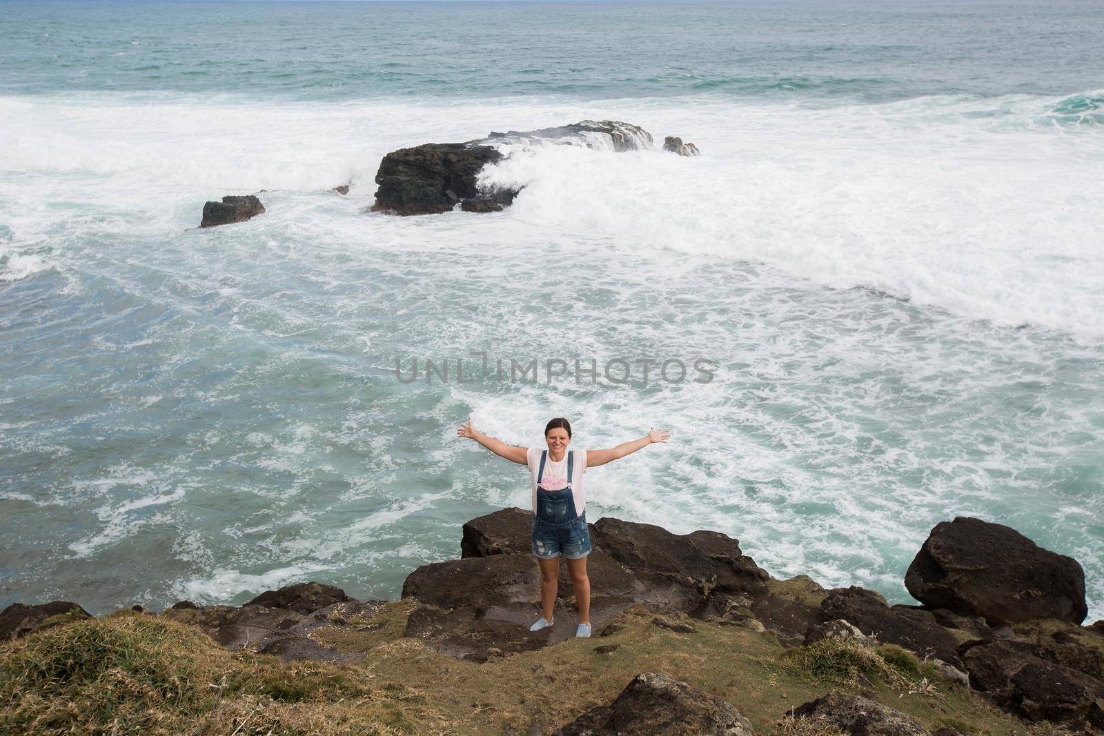 Freedom traveler woman standing with raised arms on the top of mountain and enjoy the beautiful of seascape. Mauritius