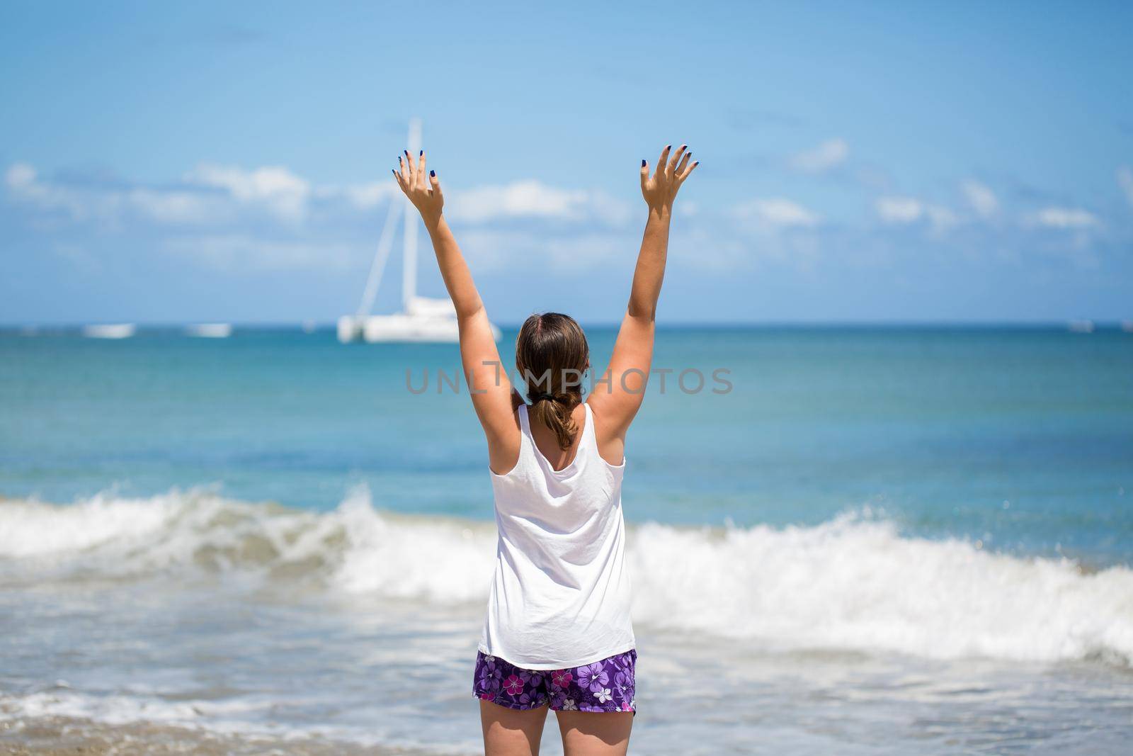 Smile Freedom and happiness woman on beach. She is enjoying serene ocean nature during travel holidays vacation outdoors