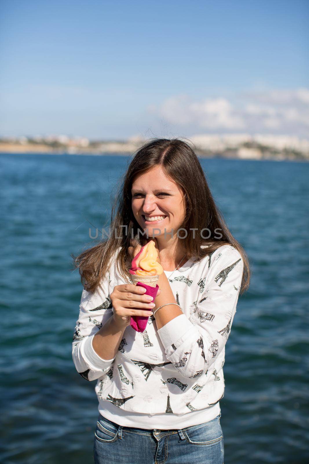 Beautiful young girl eating delicious ice cream. by StudioPeace