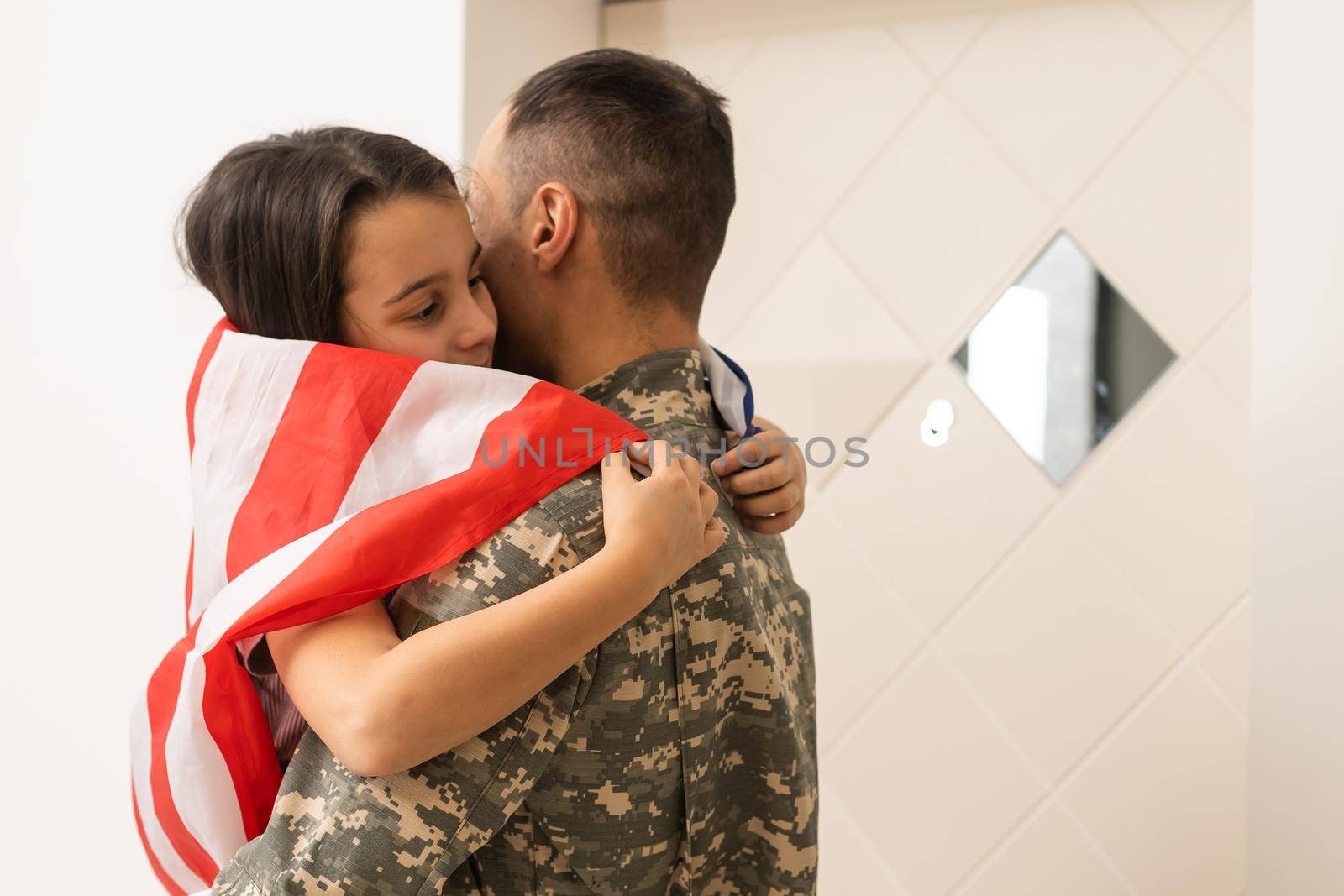 Soldier with flag of USA and his little daughter hugging, space for text.