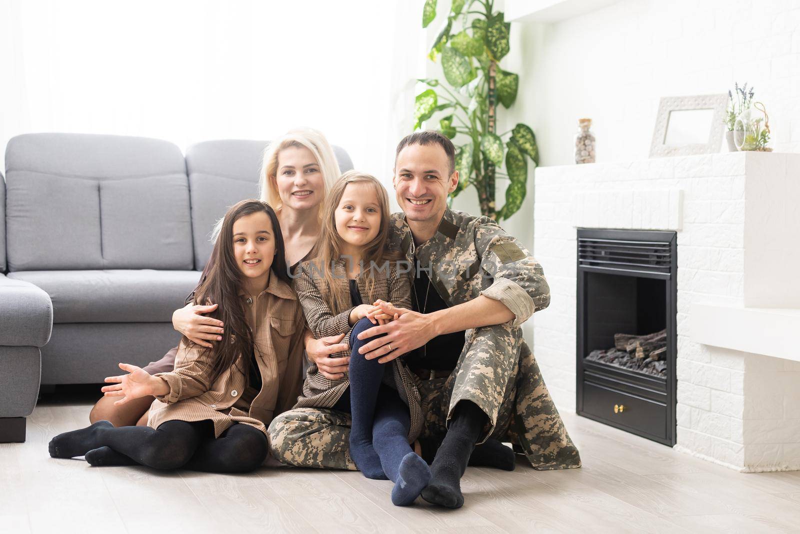 Joyful happy military man with his wife and two kids. Family togetherness and support concept by Andelov13