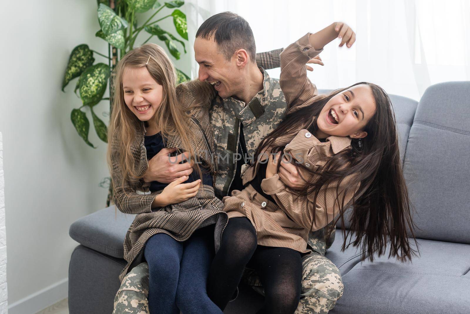 Happy military father holding daughter. family, bonding and patriotism,