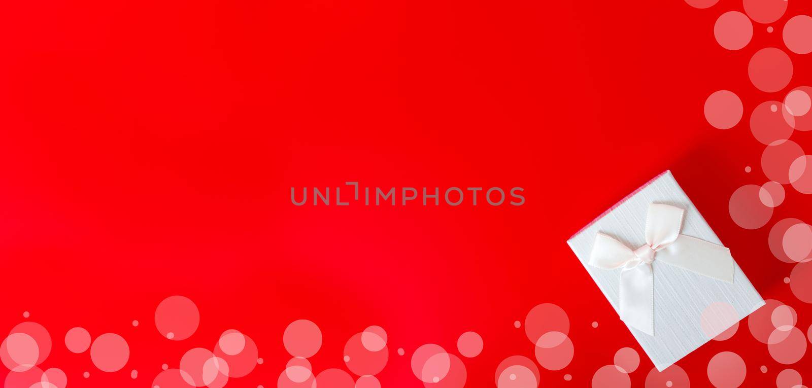 Gift box on red background. Romantic st. Valentine's day concept of greetings. place for your text by lifesummerlin