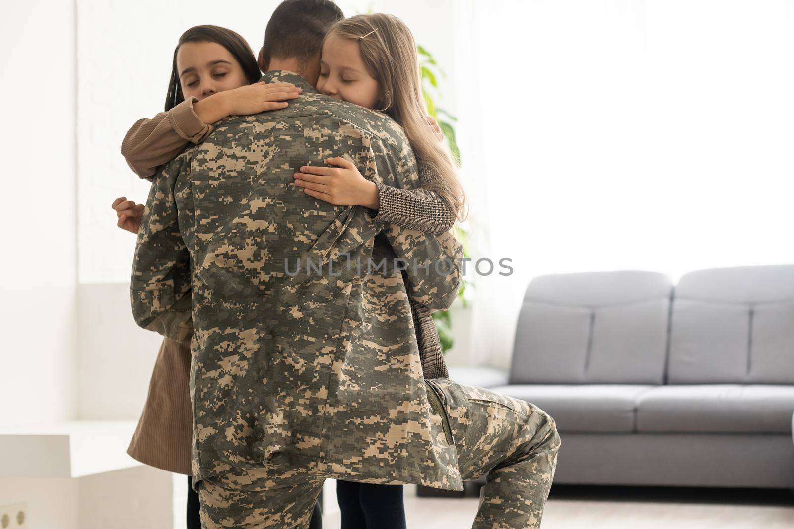 Happy military father and two daughters at home. by Andelov13