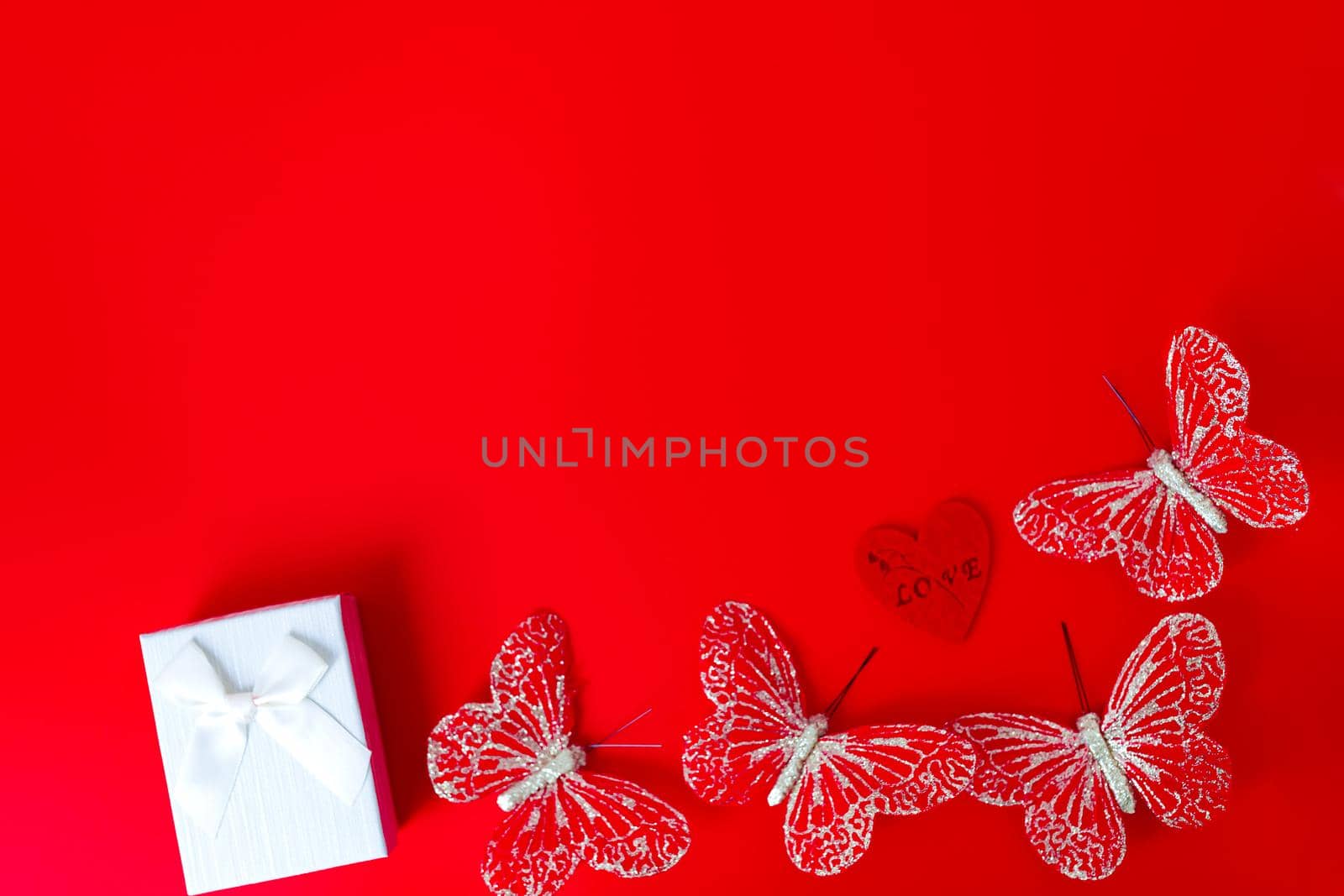 Gift box on red background. Romantic st. Valentine's day concept of greetings. place for your text by lifesummerlin