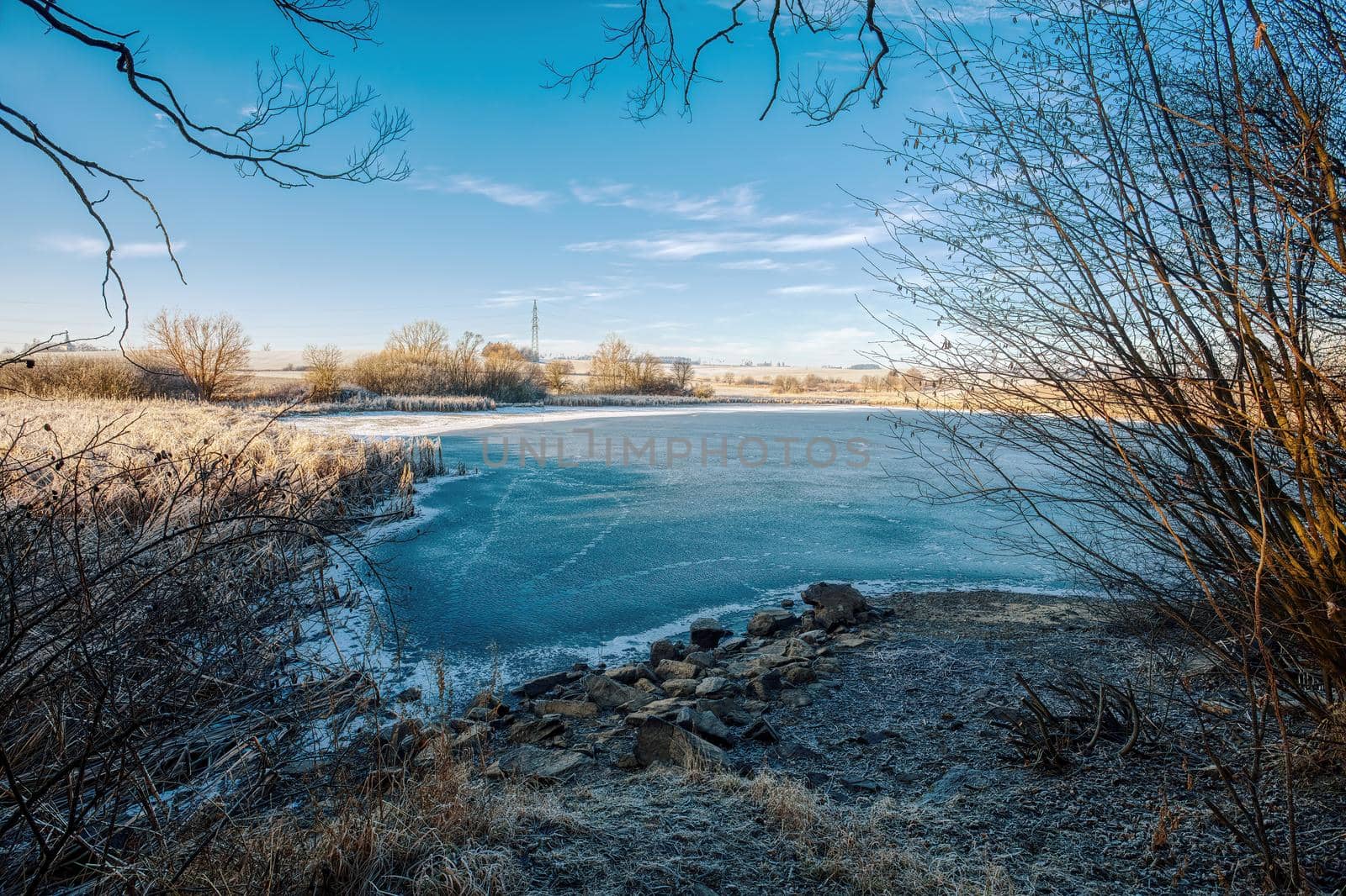 Beautiful winter rural landscape with frozen small pond. Czech beautiful highland vysocina european countryside