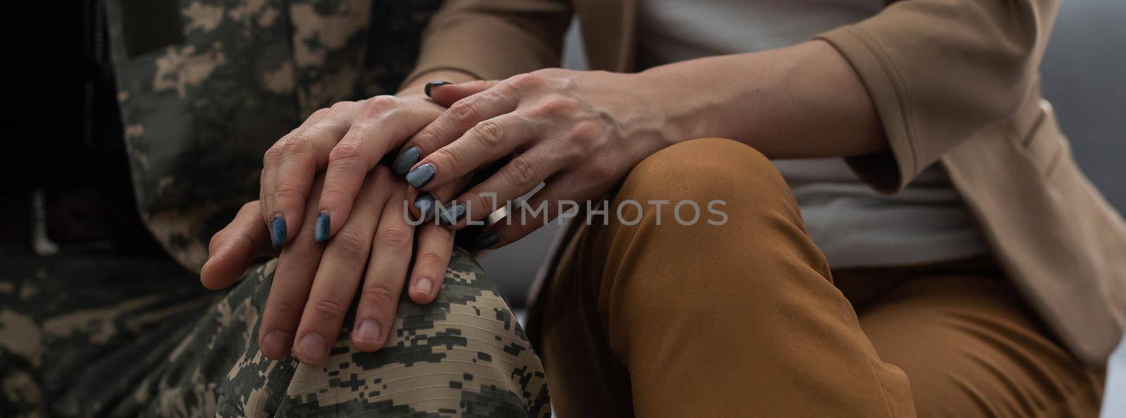 Offended military officer and girlfriend sitting on sofa, relationship problems by Andelov13