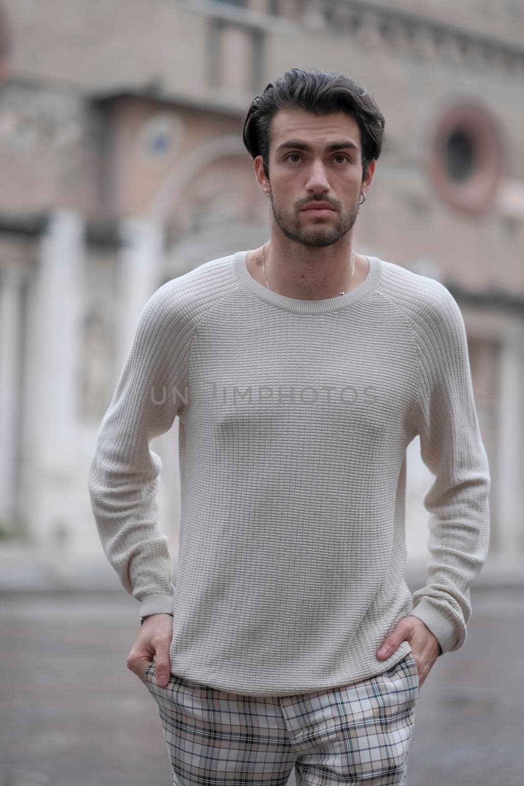 beautiful guy with white sweater in the center of reggio emilia by tinofotografie