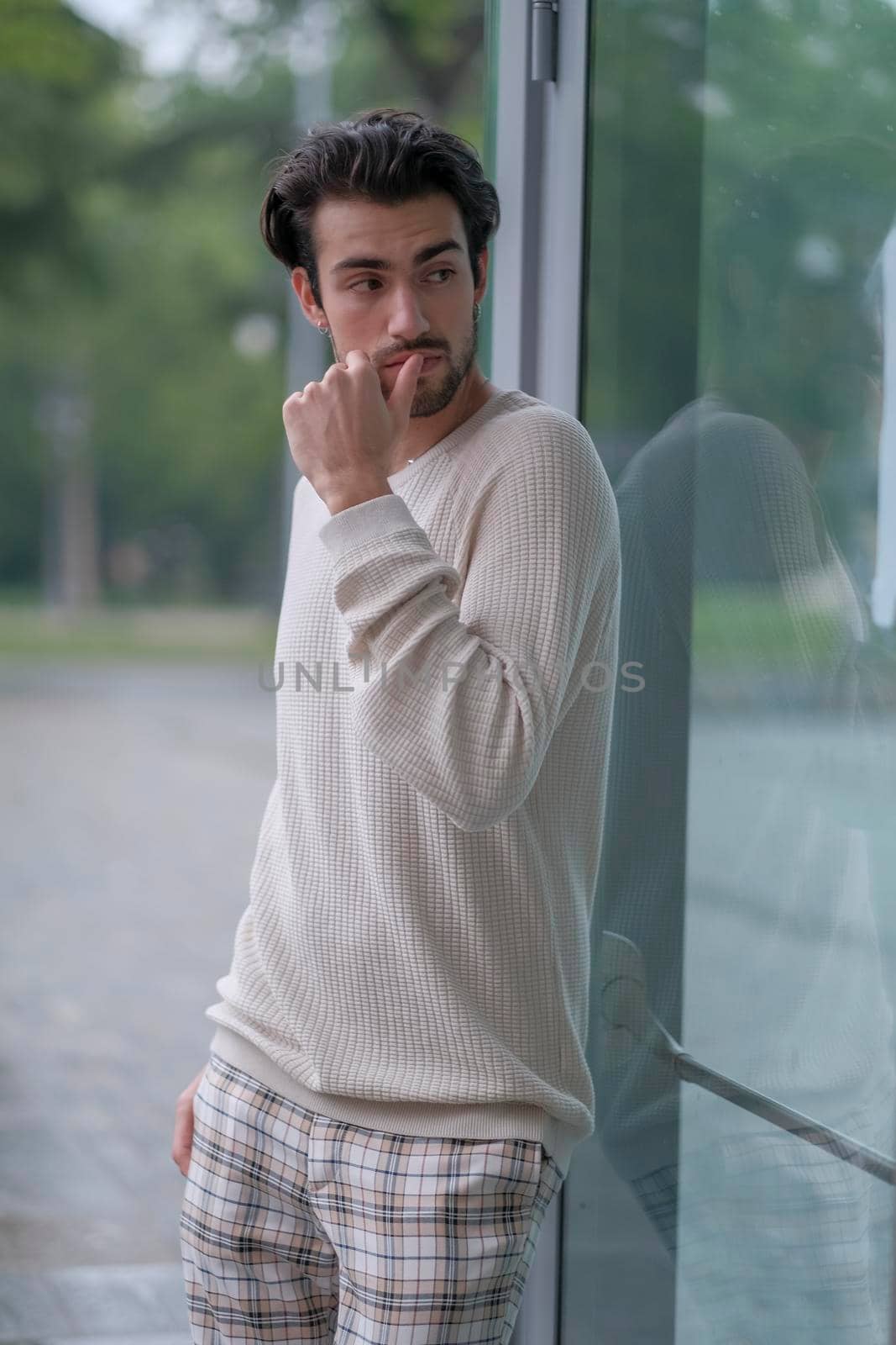 beautiful guy with white sweater in the center of reggio emilia by tinofotografie